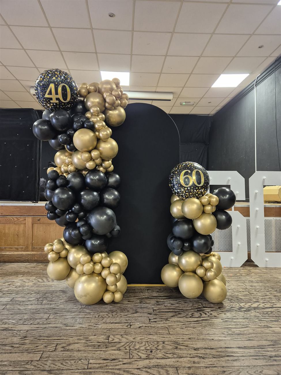 Black and gold balloon displays for a joint 40th and 60th birthday