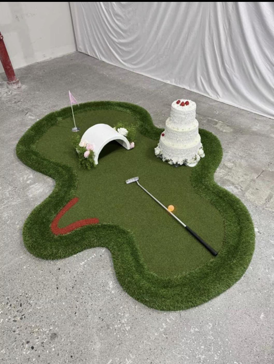 The Wedding Cake hole from our crazy golf course, with tiered cake and flower-covered tunnel