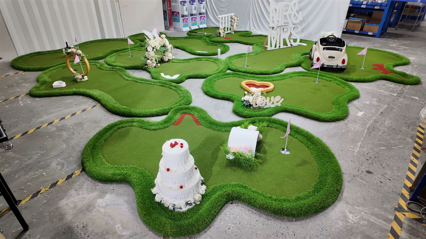 Our nine-hole wedding crazy golf course laid out in full — Mr & Mrs letters, love heart, wedding cake and more