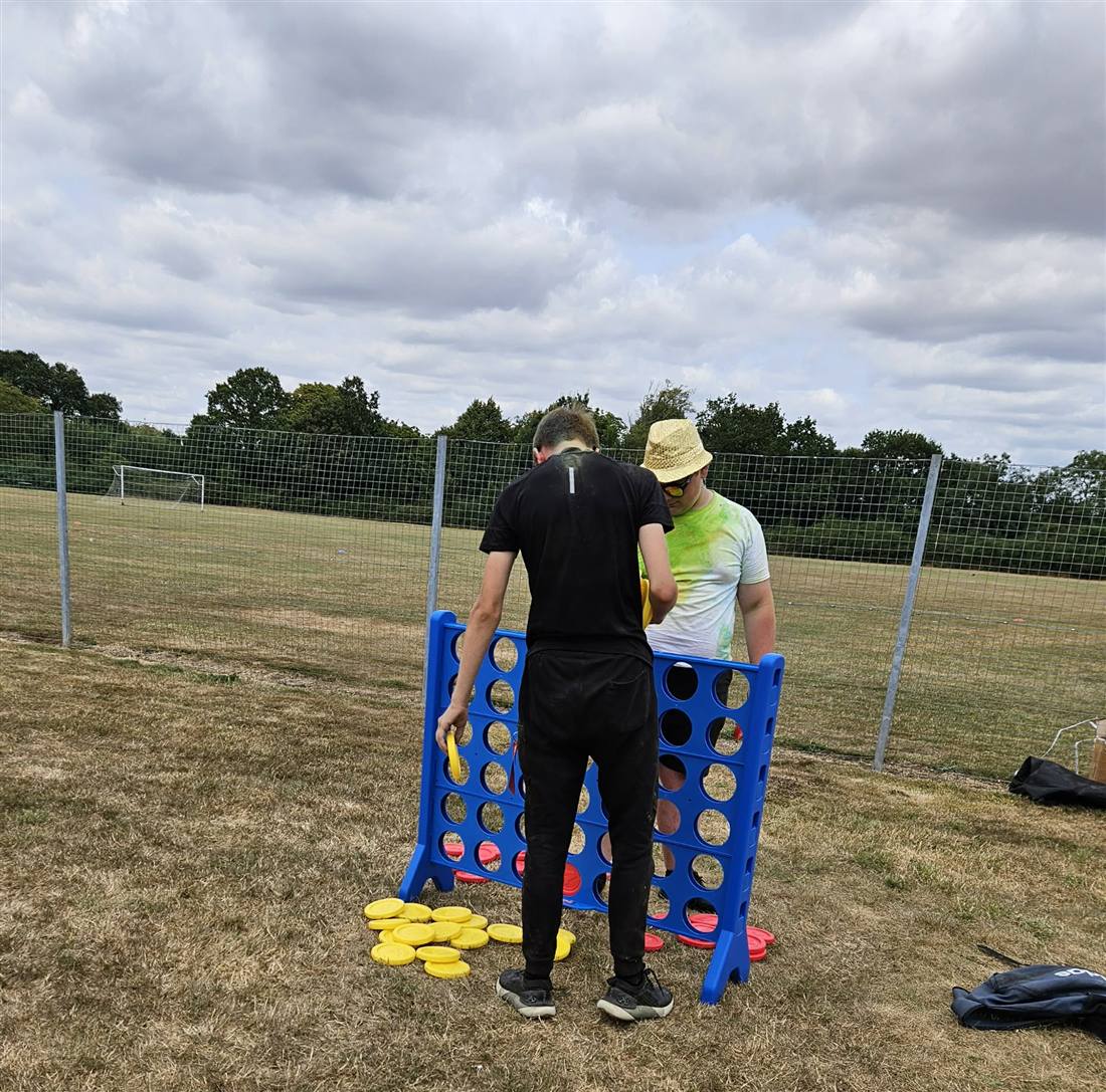 Two students playing giant Connect Four on the school field at Havant Academy