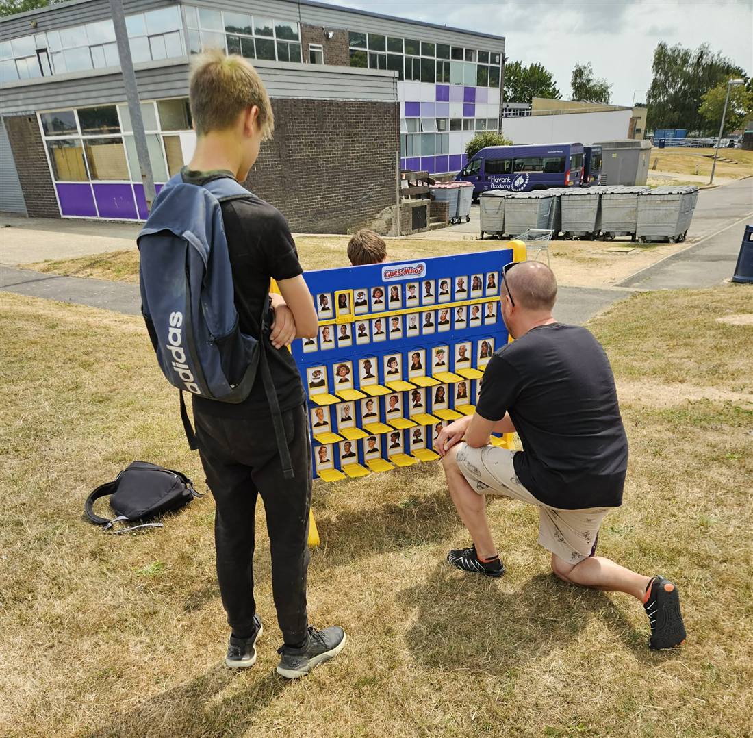 Students and staff mid-game at a giant Guess Who board at Havant Academy