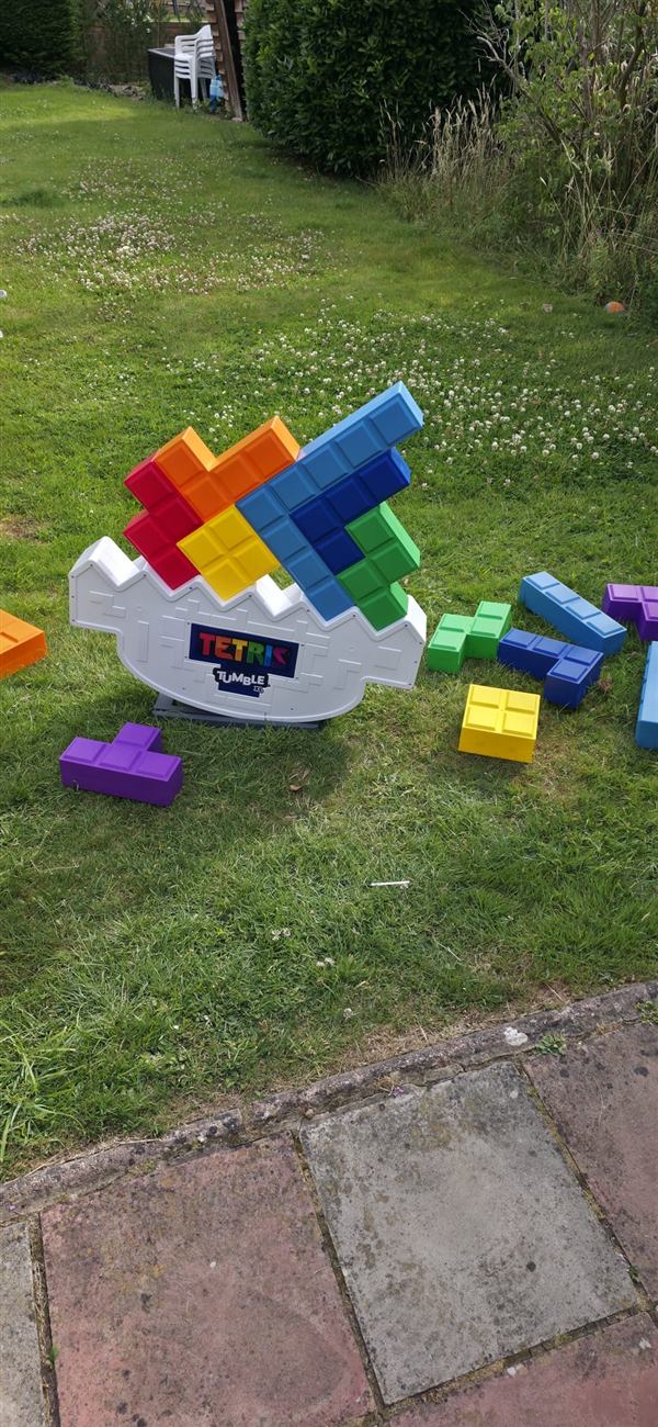 Giant Tetris Tumble mid-game in a garden
